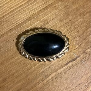 Monet black faux onyx brooch with gold tone fancy edging 1 1/2” Oval Cabochon